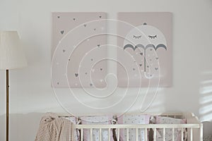 Stylish baby room with crib and cute wall art