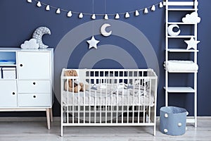 Stylish baby room interior with comfortable