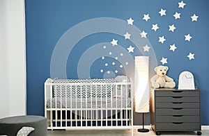 Stylish baby room interior with crib