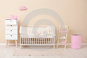 Stylish baby room interior with crib