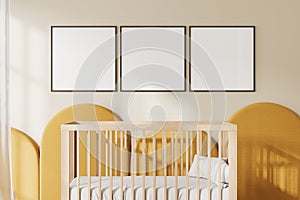 Stylish baby room interior with crib and mockup frames in row