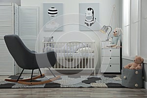 Baby room interior with crib and rocking chair