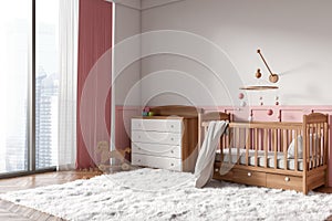 Stylish baby room interior with crib, sideboard and toys near panoramic window