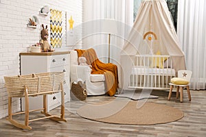 Stylish baby`s room with comfortable cot. Interior design