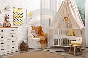 Stylish baby`s room with comfortable cot. Interior design