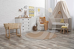 Stylish baby`s room with comfortable cot. Interior design