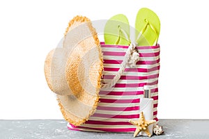 Stylish bag with beach accessories . Summer holiday concept. Top view of beach bag with sunscreen cream with space for