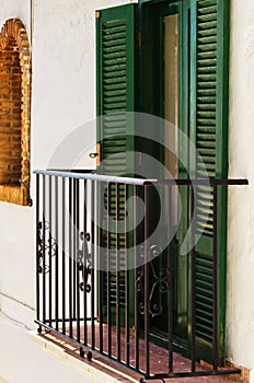 Stylish balcony with a metal railing, solid architectural elemen