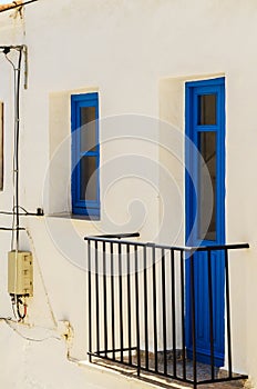 Stylish balcony with a metal railing, solid architectural elemen