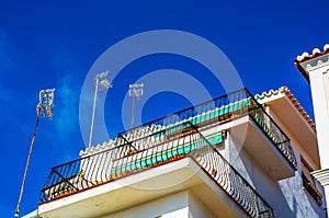 Stylish balcony with a metal railing, solid architectural element, a place of rest and relaxation