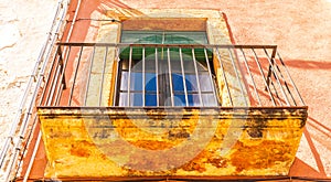 Stylish balcony with a metal railing, solid architectural element, a place of rest and relaxation, vintage decor