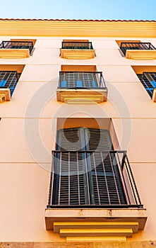 Stylish balcony with a metal railing, solid architectural element, a place of rest and relaxation, vintage decor