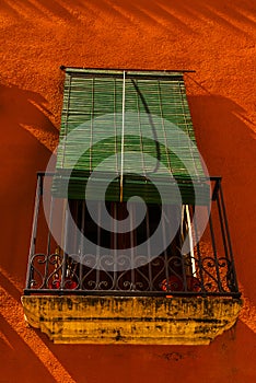 Stylish balcony with a metal railing, solid architectural element, a place of rest and relaxation, vintage decor