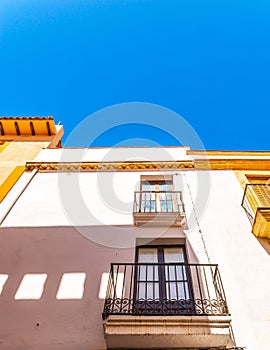 Stylish balcony with a metal railing, solid architectural element, a place of rest and relaxation, vintage decor