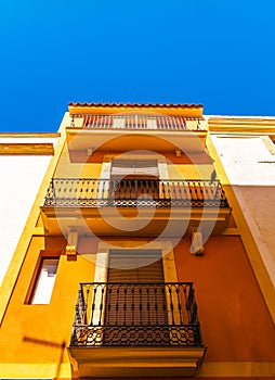 Stylish balcony with a metal railing, solid architectural element, a place of rest and relaxation, vintage decor