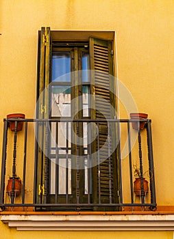 Stylish balcony with a metal railing, solid architectural element, a place of rest and relaxation, vintage decor