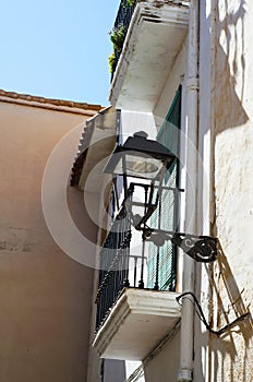 Stylish balcony with a metal railing, solid architectural element, a place of rest and relaxation, vintage decor