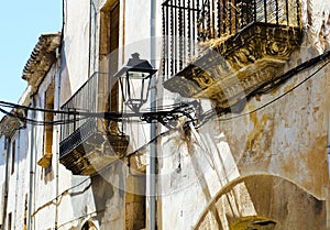 Stylish balcony with a metal railing, solid architectural element, a place of rest and relaxation, vintage decor