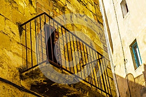 Stylish balcony with a metal railing, solid architectural element, a place of rest and relaxation, vintage decor