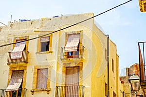 Stylish balcony with a metal railing, solid architectural element, a place of rest and relaxation, vintage decor