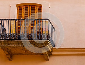 Stylish balcony with a metal railing, solid architectural element, a place of rest and relaxation, vintage decor