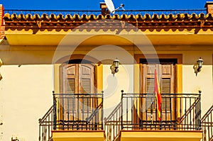 Stylish balcony with a metal railing, solid architectural element, a place of rest and relaxation, vintage decor