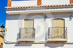 Stylish balcony with a metal railing, solid architectural element, a place of rest and relaxation, vintage decor