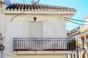 Stylish balcony with a metal railing, solid architectural element, a place of rest and relaxation, vintage decor