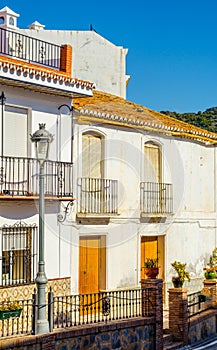 Stylish balcony with a metal railing, solid architectural element, a place of rest and relaxation, vintage decor