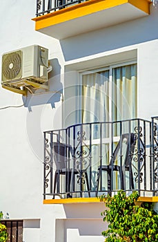 Stylish balcony with a metal railing, solid architectural element, a place of rest and relaxation, vintage decor