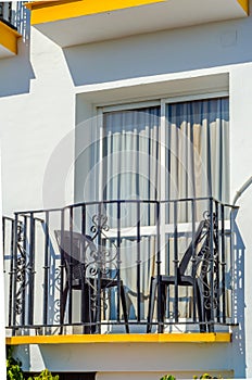 Stylish balcony with a metal railing, solid architectural element, a place of rest and relaxation, vintage decor