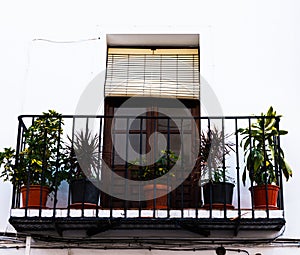 Stylish balcony with a metal railing, solid architectural element, a place of rest and relaxation, vintage decor