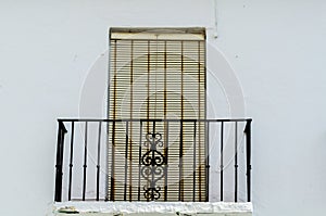 Stylish balcony with a metal railing, solid architectural element, a place of rest and relaxation, vintage decor