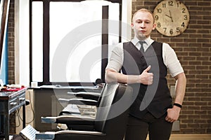 Barber invites to have seat on chair at barbershop