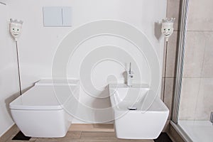 Stylish bathroom with bidet and WC in white