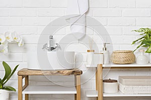 Stylish bathroom interior with round vessel sink and various accessories