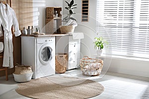 Stylish bathroom interior with washing machine