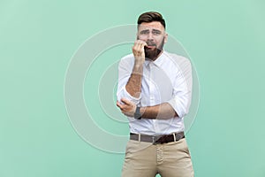 Stylish bearded businessman with warried. Hipster guy having shocked face, looking at camera. Indoor, studio shot,