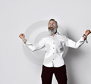 Stylish bearded hipster man with hallelujah gesture looking upward