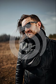 Stylish bearded man with glasses and a black jacket