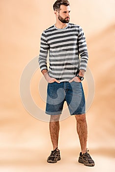 Stylish bearded man posing in striped sweatshirt