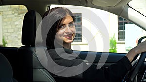 Stylish beautiful businesswoman sitting in car salon