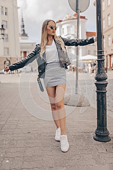 Stylish beautiful girl posing in the street. Fashion summer photo photo