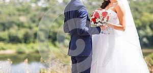 Stylish beautiful happy bride and groom, wedding celebrations outdoors
