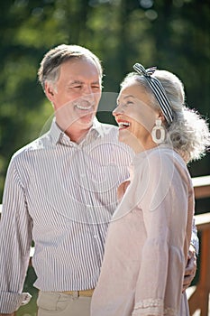 Stylish beautiful wife laughing while talking with husband