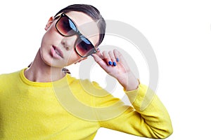 Stylish beautiful woman in sunglasses and bright sweater