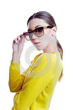 Stylish beautiful woman in sunglasses and yellow sweater