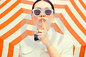Stylish beautiful woman wearing white chemise and sunglasses