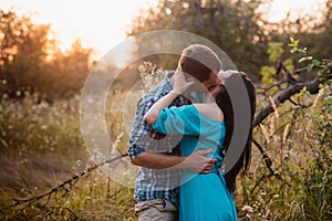 Stylish beautiful young couple standing outdoors at sunset light