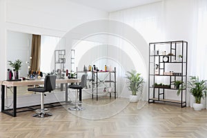 Stylish beauty salon interior with hairdresser`s workplace